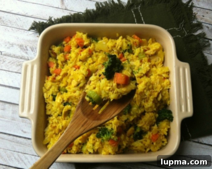 Fragrant Curried Chicken and Rice Bake 3 Curried Chicken and Rice Casserole with a serving spoon