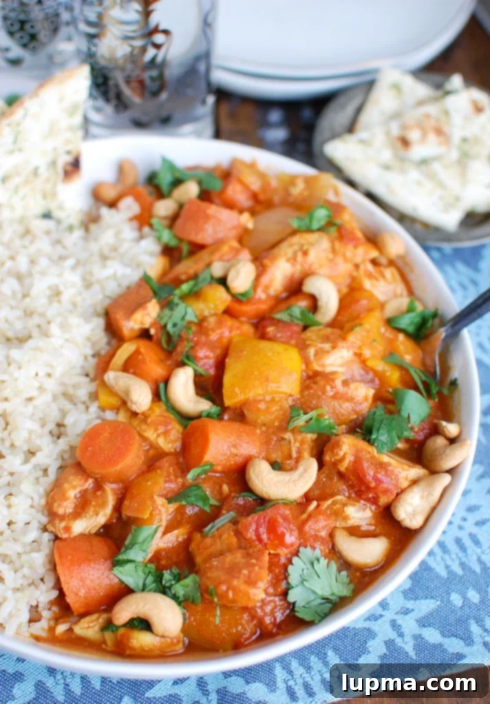 Effortless Slow Cooker Chicken Curry 2 Creamy Slow Cooker Coconut Curry Chicken with Cashews, ready to be served over rice.