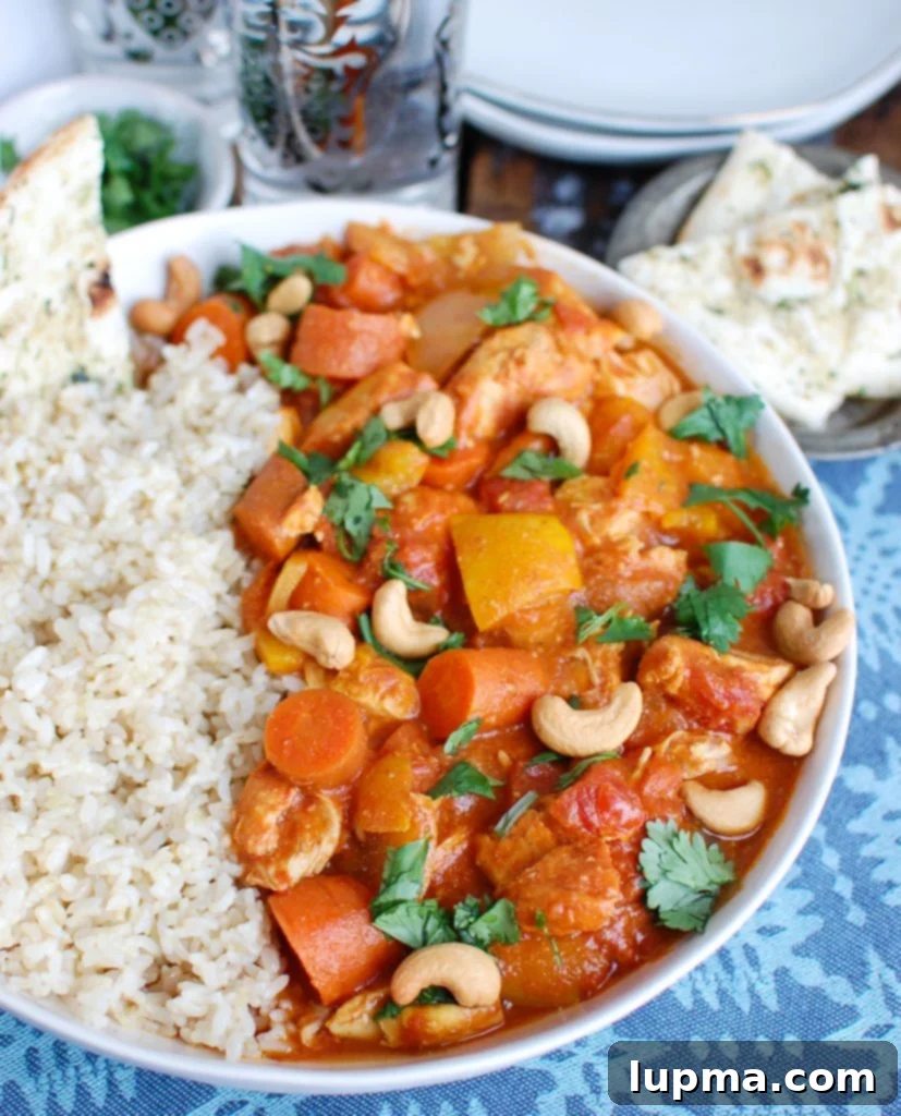 Effortless Slow Cooker Chicken Curry 5 Slow Cooker Coconut Curry Chicken garnished with fresh cilantro in a serving bowl.