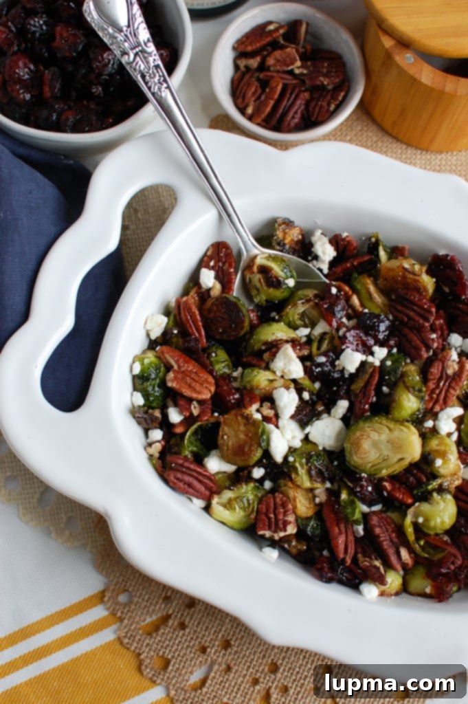 Crispy Brussels Sprouts with Tangy Cranberries 6 Another perspective of Roasted Brussels Sprouts with Cranberries, highlighting the generous amount of goat cheese for a richer flavor profile.