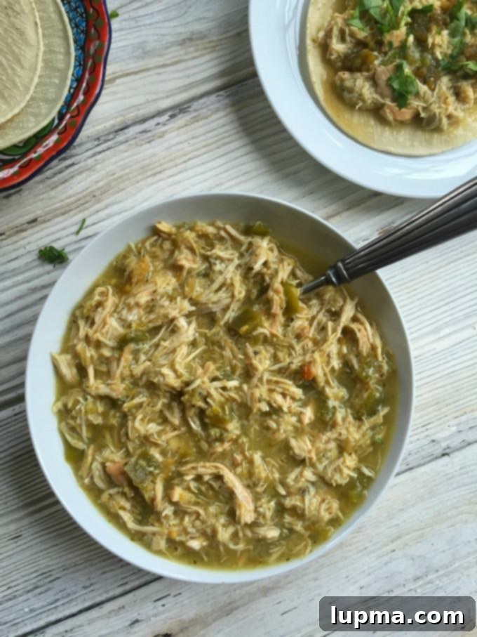 Zesty Slow Cooker Salsa Verde Chicken Tacos 2 Slow Cooker Salsa Verde Chicken Tacos served in soft tortillas with fresh toppings