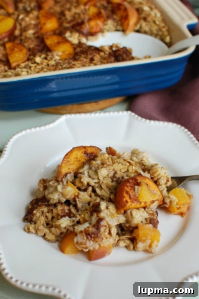 Peaches and Cream Baked Oats 3 Fresh ingredients laid out for Peaches and Cream Baked Oatmeal, including oats, peaches, cinnamon, and maple syrup.