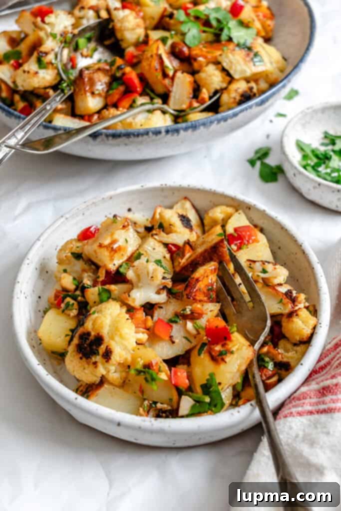 Creamy Cauliflower Potato Salad 5 A small portion of Cauliflower Potato Salad in a rustic bowl, garnished with fresh parsley