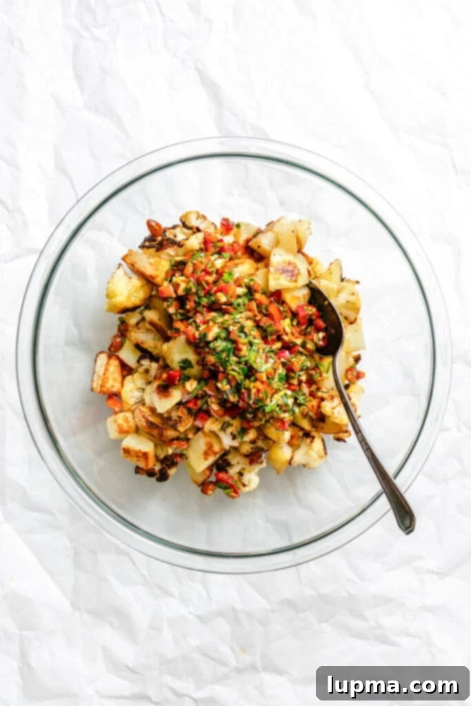 Creamy Cauliflower Potato Salad 8 A large bowl of Cauliflower Potato Salad, ready to be served, showing the mix of roasted vegetables and the rich sauce