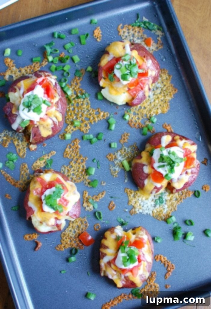 Ultimate Loaded Smashed Potatoes 4 Loaded Smashed Potatoes are crispy on the outside and soft on the inside and loaded with cheese, sour cream, tomatoes, green onion and cilantro. These make an easy family meal or appetizer for game day or a party!
