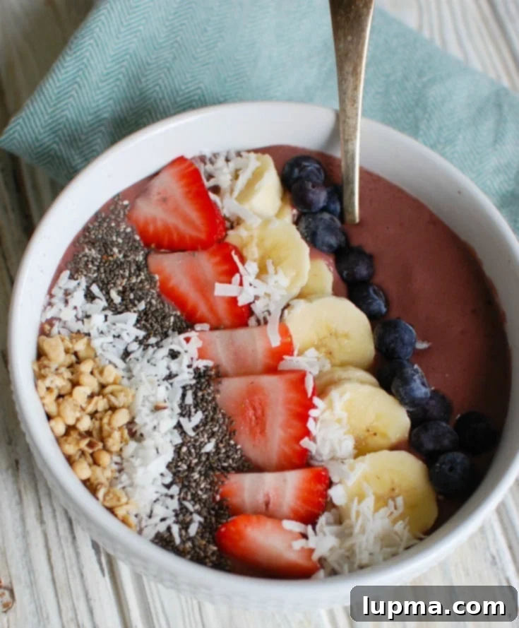 Vibrant Chia Seed Fruit Medley 2 A vibrant Chia Seeds Fruit Bowl with a blue napkin, ready to be enjoyed.