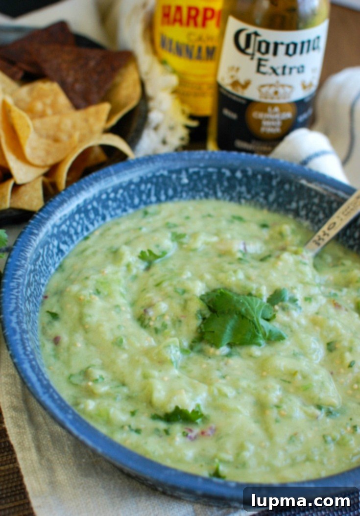 Zesty Avocado Tomatillo Salsa 2 Avocado Tomatillo Salsa in a beautiful blue bowl, ready to be served as a fresh dip or topping.