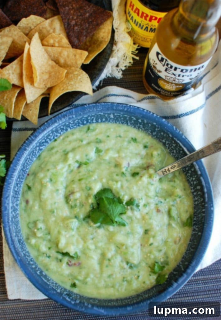 Zesty Avocado Tomatillo Salsa 3 Avocado Tomatillo Salsa served with chips and a refreshing beer, perfect for summer gatherings.