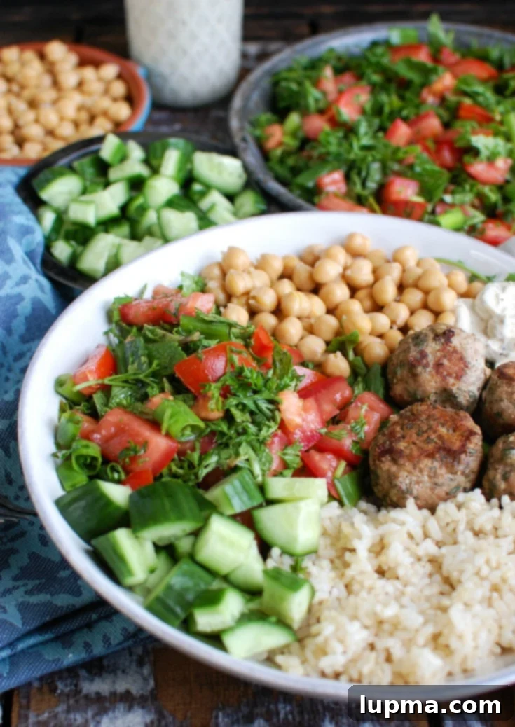 Sun-Kissed Mediterranean Turkey Meatballs 5 A serving of Mediterranean Baked Turkey Meatballs with a spoon, highlighting their tender texture and delicious appearance.