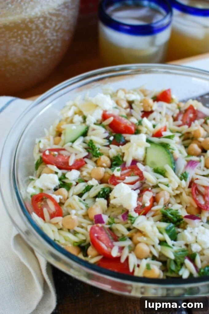 Cool Off with 13 Refreshing Summer Salads 3 A large bowl of fresh summer salad with green leaves, tomatoes, and other colorful vegetables.