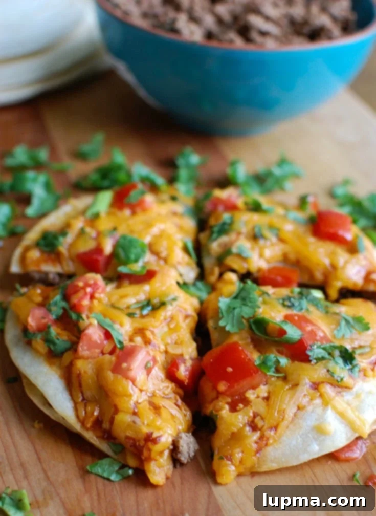 Cheesy Broccoli Chicken Bake 11 A vibrant Mexican Pizza topped with ground beef, refried beans, salsa, and bubbling Sargento Monterey Jack cheese, garnished with fresh tomatoes, green onion, and cilantro.