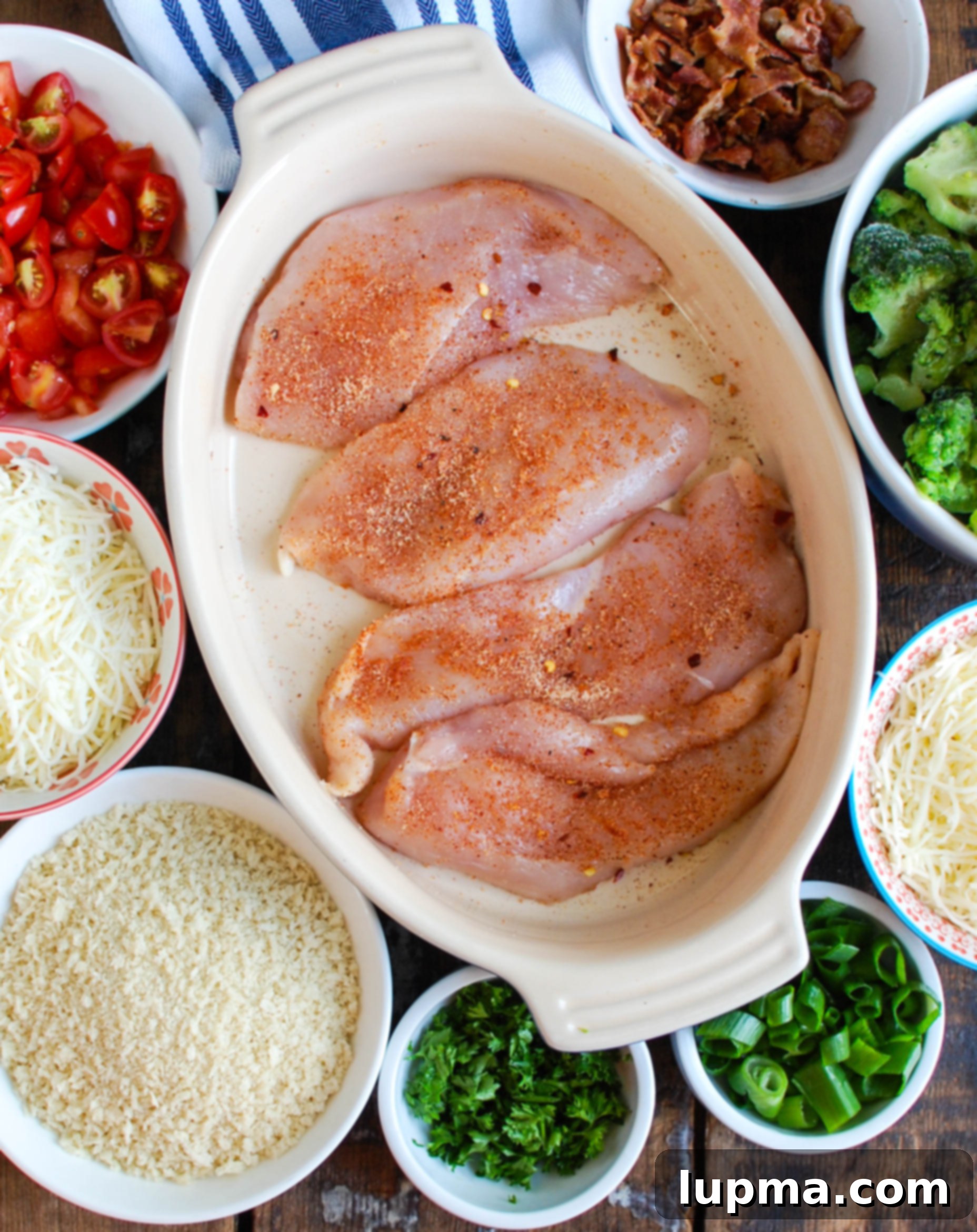 Cheesy Broccoli Chicken Bake 4 Ingredients for Baked Broccoli Cheese Chicken arranged on a cutting board, including chicken, broccoli, Sargento shredded cheese, and spices, ready for preparation.