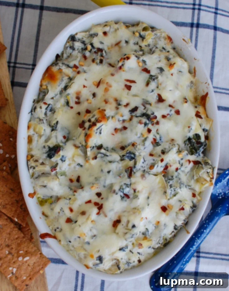 Zesty Lemon Spinach Artichoke Dip 3 Lemon Spinach Artichoke Dip served in a stylish white dish