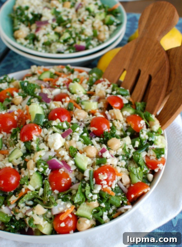 Mediterranean Roasted Cauliflower & Chickpea Salad 2 Mediterranean Chickpea Cauliflower Salad in a bowl, showcasing fresh ingredients.