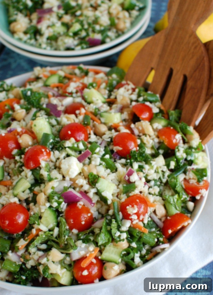 Mediterranean Roasted Cauliflower & Chickpea Salad 6 Mediterranean Chickpea Cauliflower Salad being served with tongs.