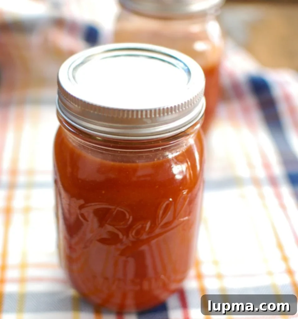 Two jars of homemade barbecue sauce, ready for use or gifting.