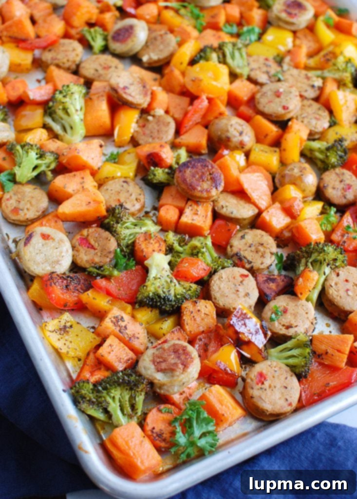 Golden Roasted Chicken Sausage and Garden Veggies 2 Vibrant Sheet Pan Chicken Sausage and Vegetables with bell peppers, broccoli, and sweet potatoes on a baking sheet, ready for roasting.