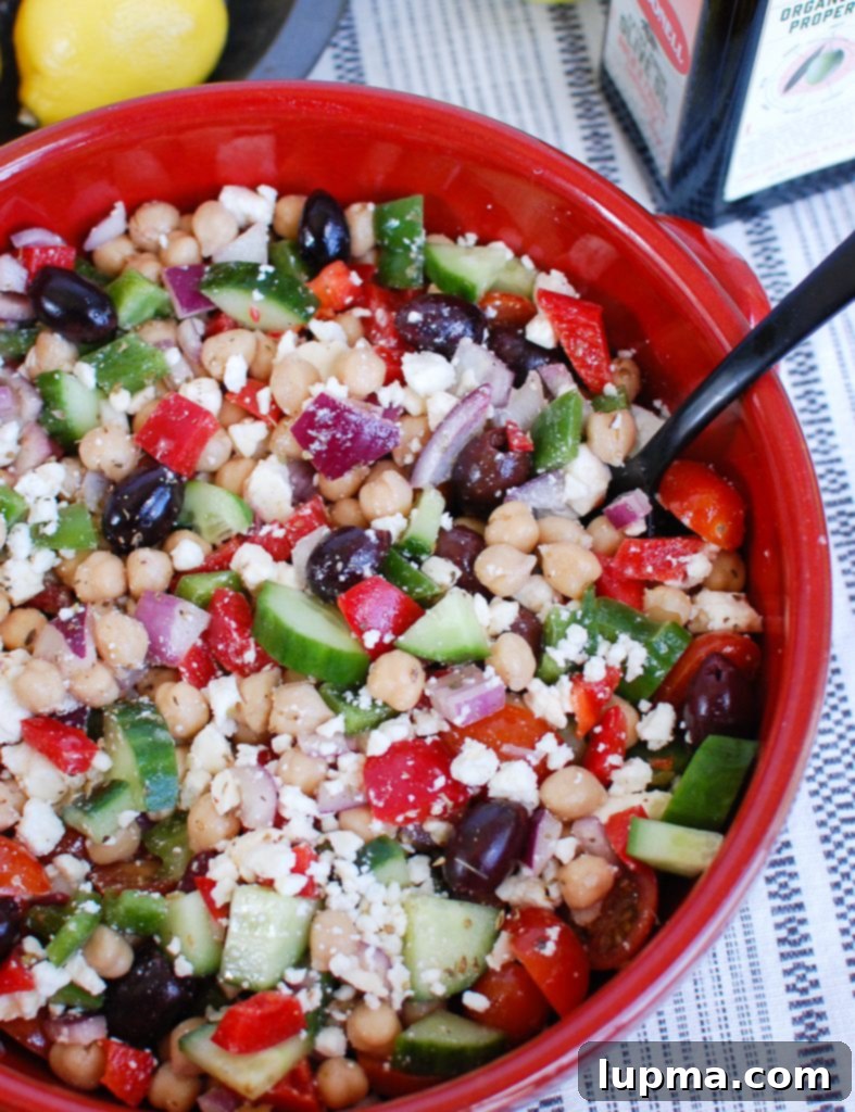 Zesty Mediterranean Chickpea Medley 2 Vibrant Greek Chickpea Salad served in a rustic red bowl