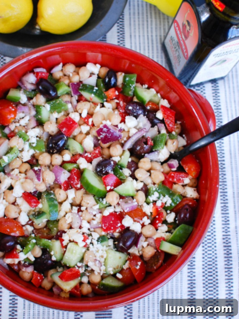 Zesty Mediterranean Chickpea Medley 3 Freshly prepared Greek Chickpea Salad in a vibrant red bowl, ready to serve