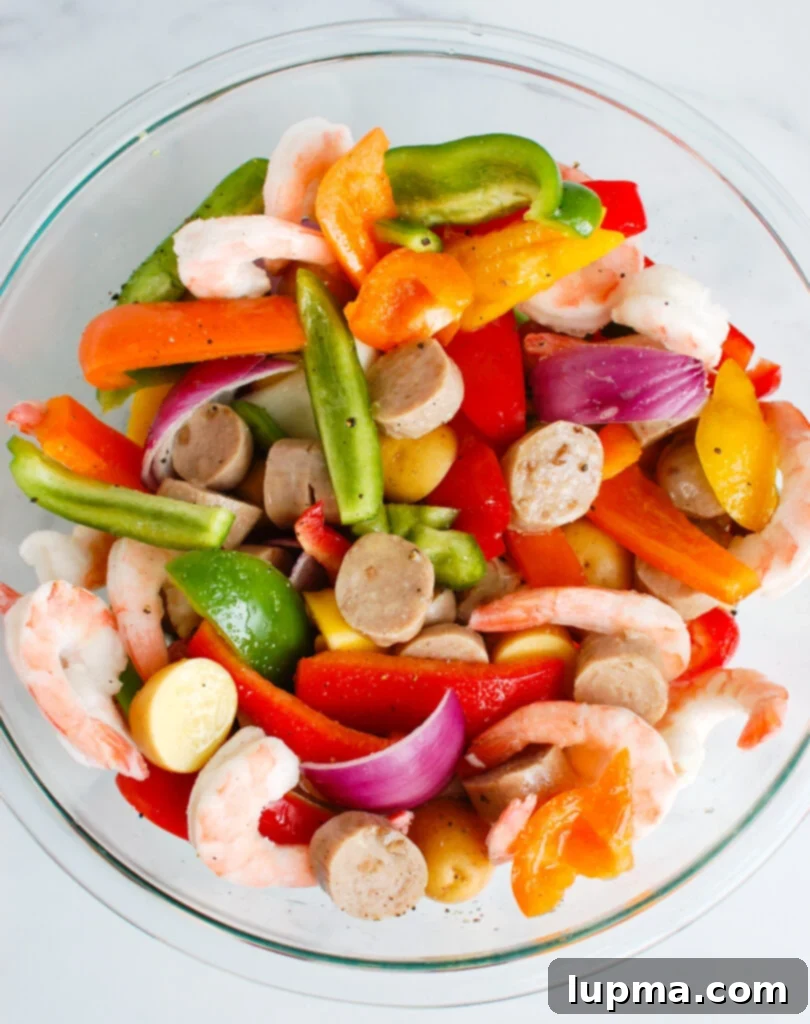 Sausage & Shrimp Foil Pack Dinners 3 Sausage and Shrimp Foil Packets in a clear bowl with all ingredients visible
