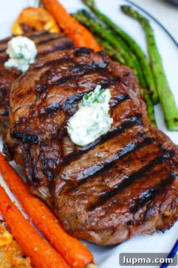 Zesty Lemon Garlic Butter Grilled Ribeye 2 Perfectly grilled Lemon Garlic Butter Ribeye steak on a plate, ready to be served
