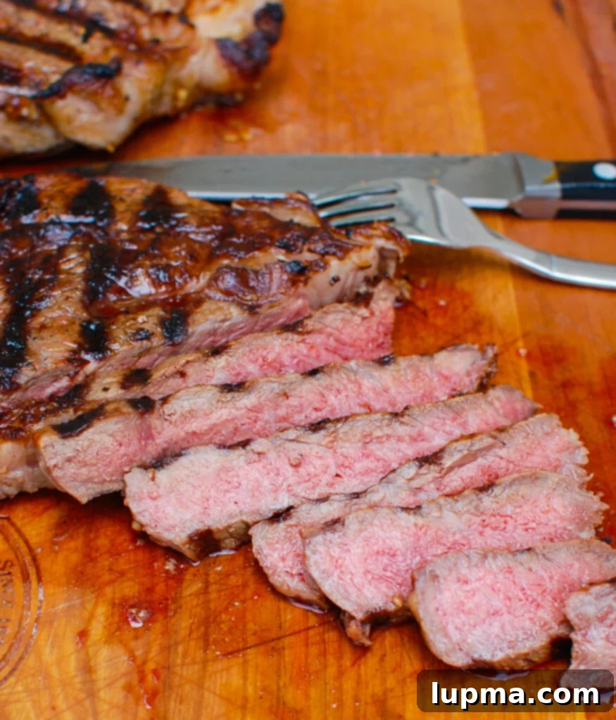 Zesty Lemon Garlic Butter Grilled Ribeye 6 Perfectly cooked and sliced Lemon Garlic Butter Grilled Ribeye, showing its juicy interior and crispy crust