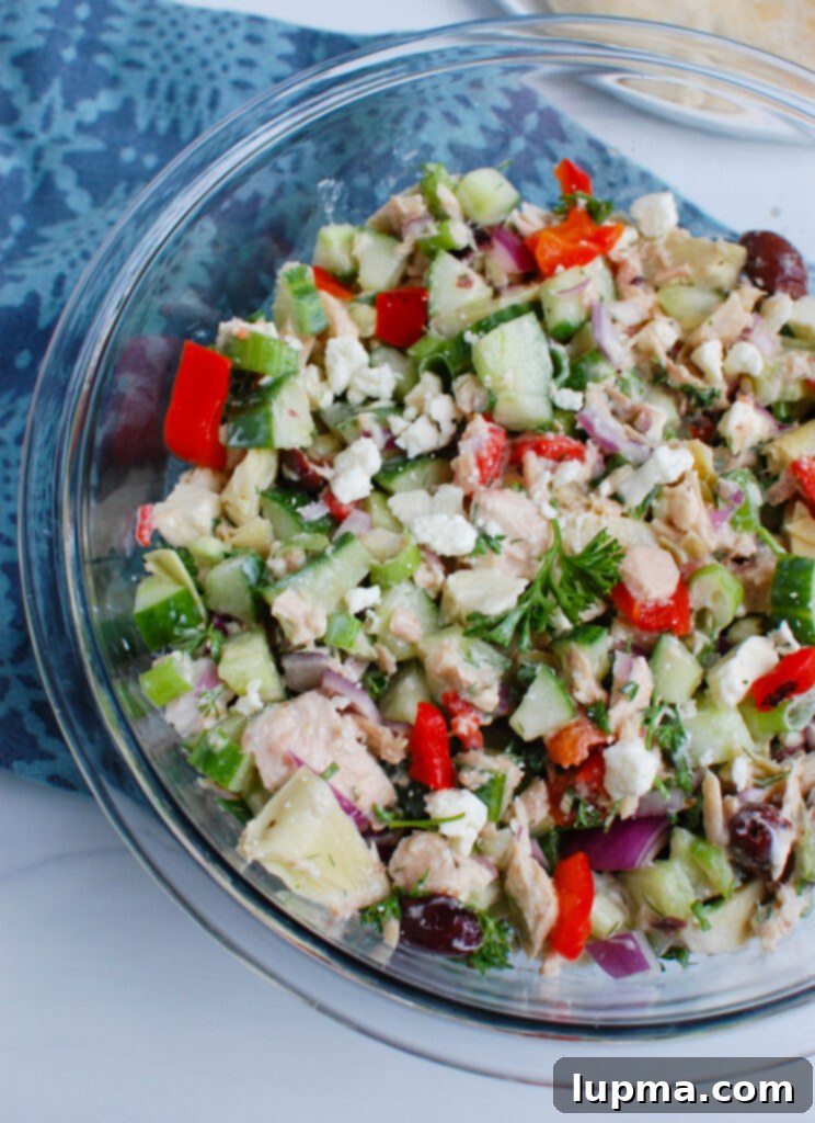 Sun-Kissed Mediterranean Tuna Medley 2 A bowl of Mediterranean Tuna Salad, garnished with fresh dill and feta cheese, ready to be served.