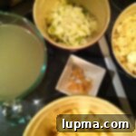 A ladle serving Skinny Baked Potato Soup into a bowl