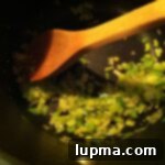 Garnishing the Skinny Baked Potato Soup with fresh herbs