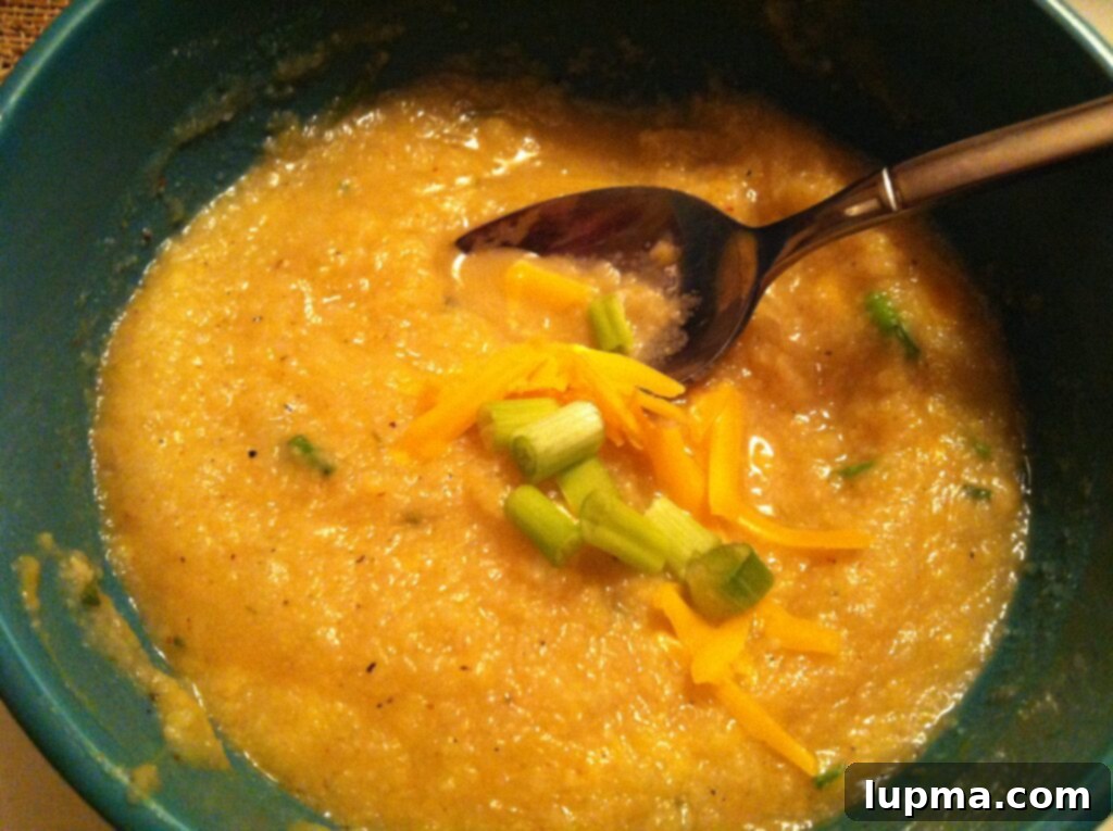 Close-up of Skinny Baked Potato Soup, highlighting the creamy texture and small pieces of cauliflower and potato, ready to be enjoyed.