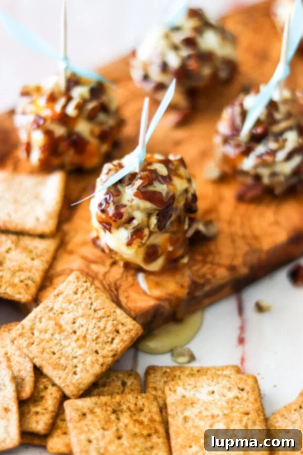 Honey-Kissed Goat Cheese Bites 8 Honey Goat Cheese Balls on cutting board