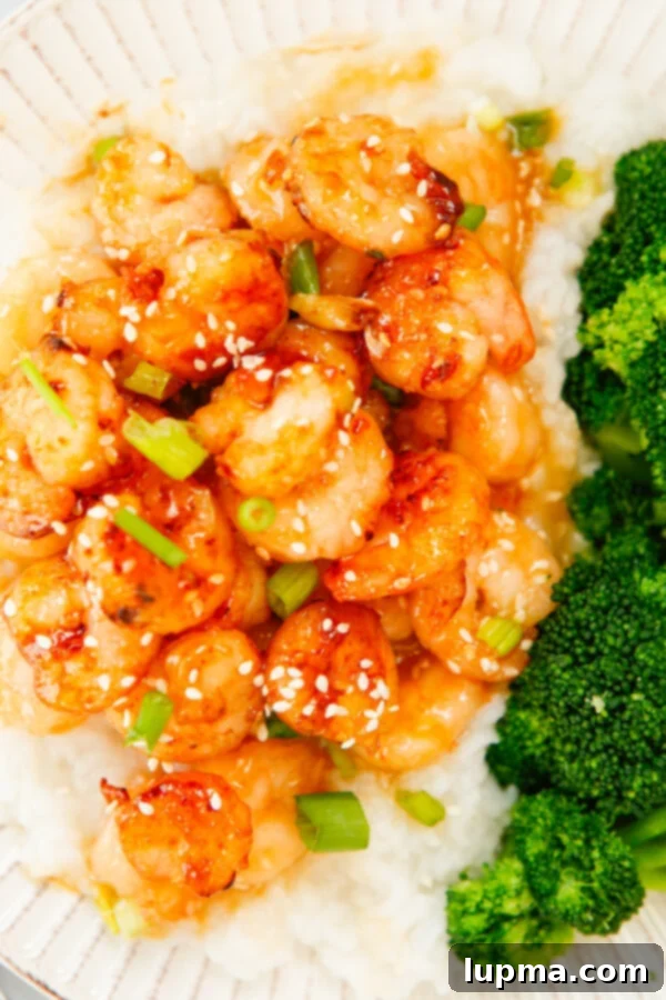 Sweet Heat Sriracha Shrimp 10 A large serving of Honey Garlic Sriracha Shrimp, generously garnished with fresh green onions