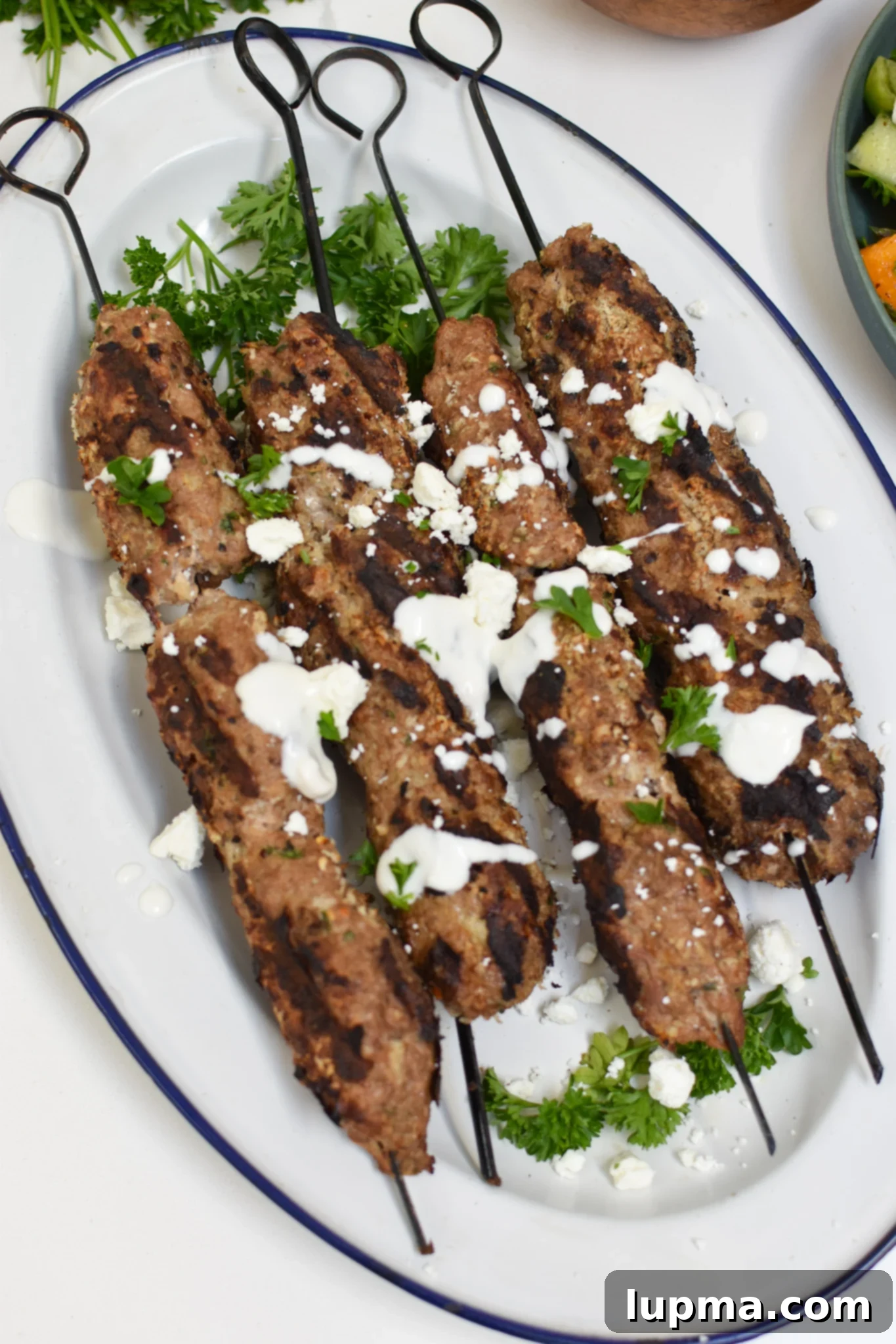Turkish Kofta Recipe 2 Turkey Kofta Kebab Recipe on a white platter.