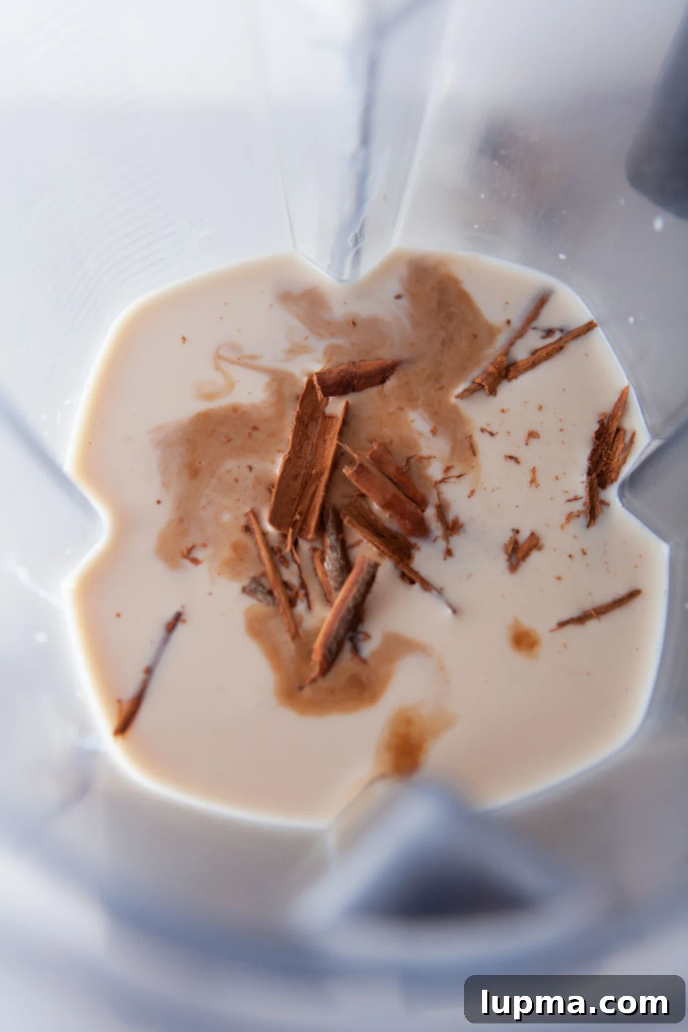 The Ultimate Horchata Recipe 5 A blender filled with the Horchata mixture, showcasing the milky, creamy consistency before straining.