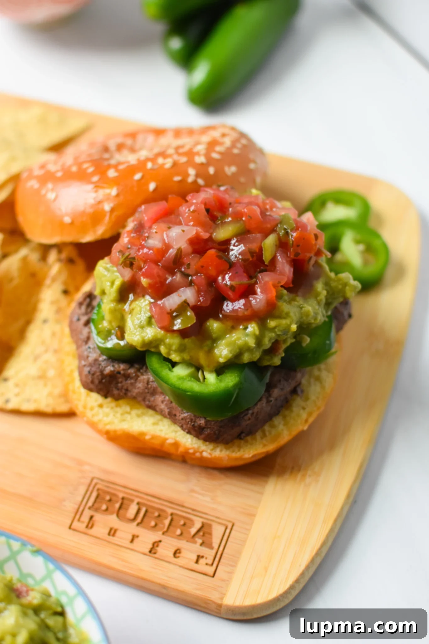 Southwest Sensation Burger 4 Tex Mex Burger on cutting board with ingredients.