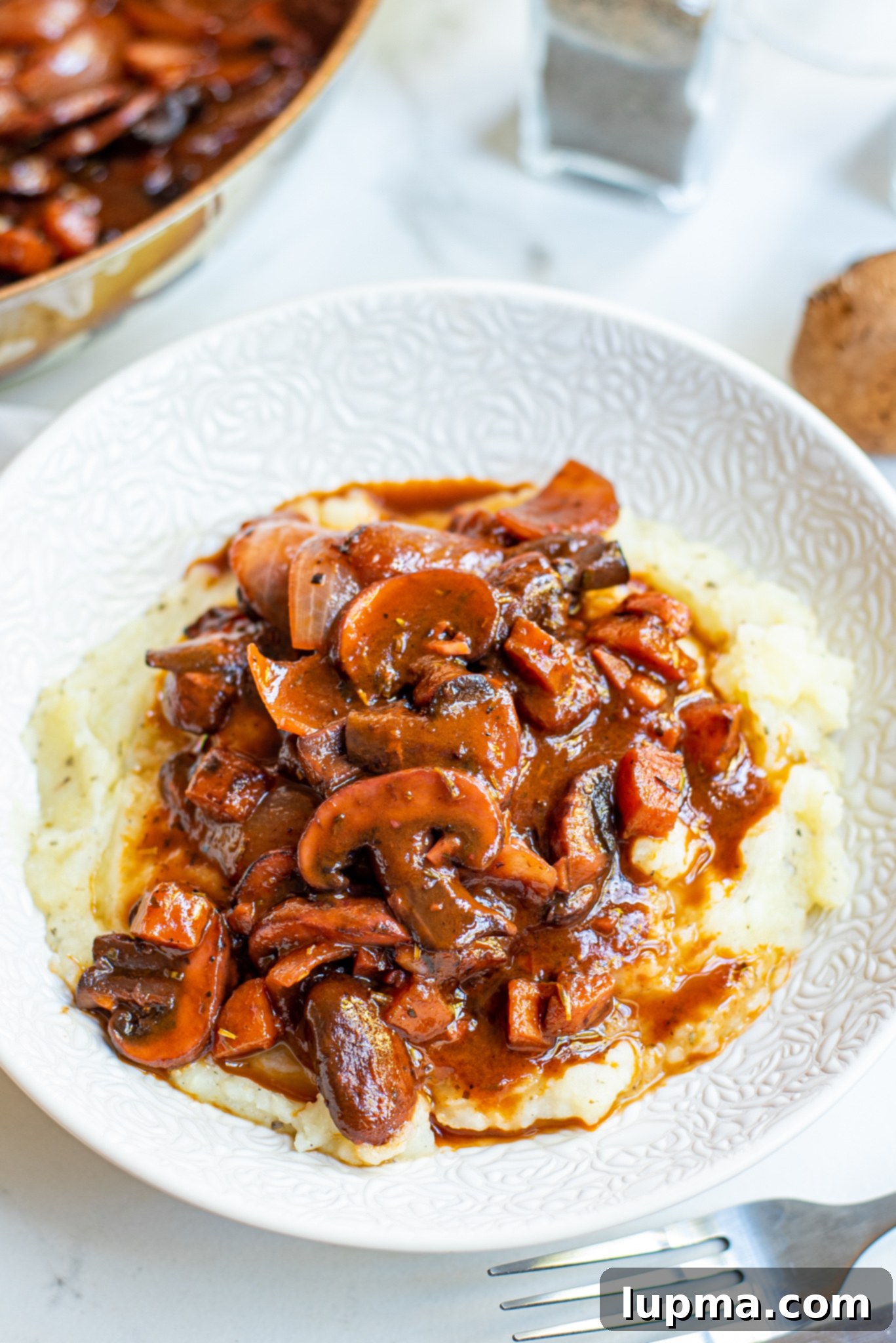 Hearty Mushroom Bourguignon 2 Mushroom Bourguignon on white plate.