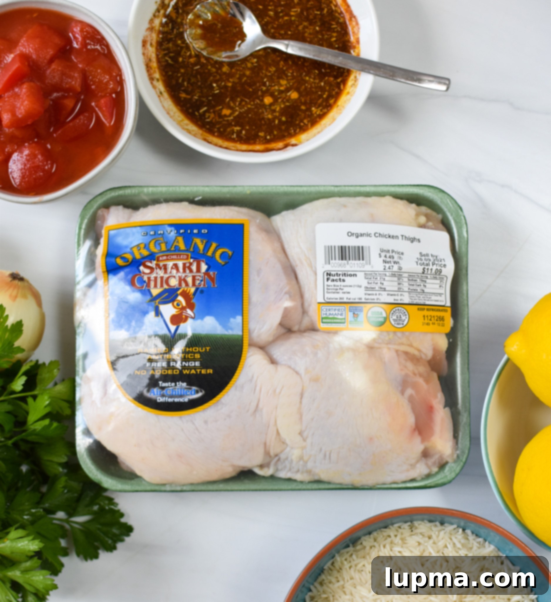 Sun-Kissed Mediterranean Chicken & Rice 3 All the fresh ingredients for One Pot Mediterranean Chicken and Rice laid out on a wooden cutting board.