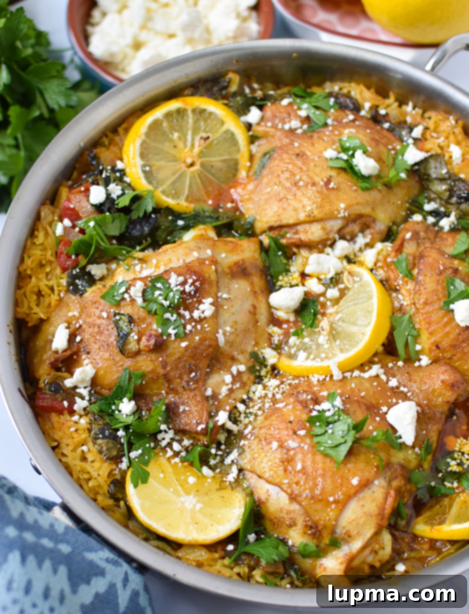 Sun-Kissed Mediterranean Chicken & Rice 8 A close-up of One Pot Mediterranean Chicken and Rice, topped with creamy feta cheese and vibrant parsley.
