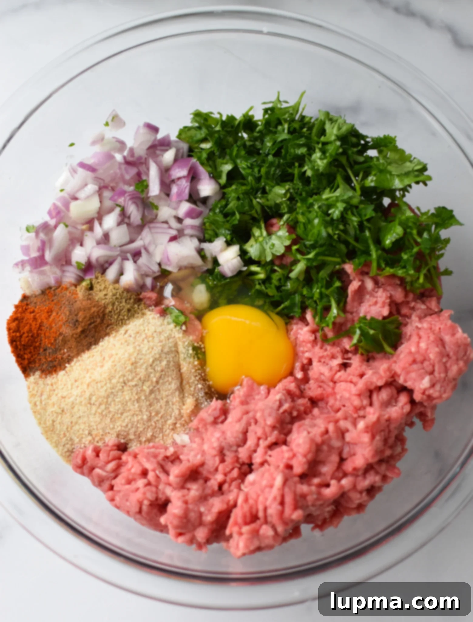 Mediterranean Golden Beef Meatballs 5 Ingredients for Mediterranean Baked Beef Meatballs, expertly mixed in a large bowl.