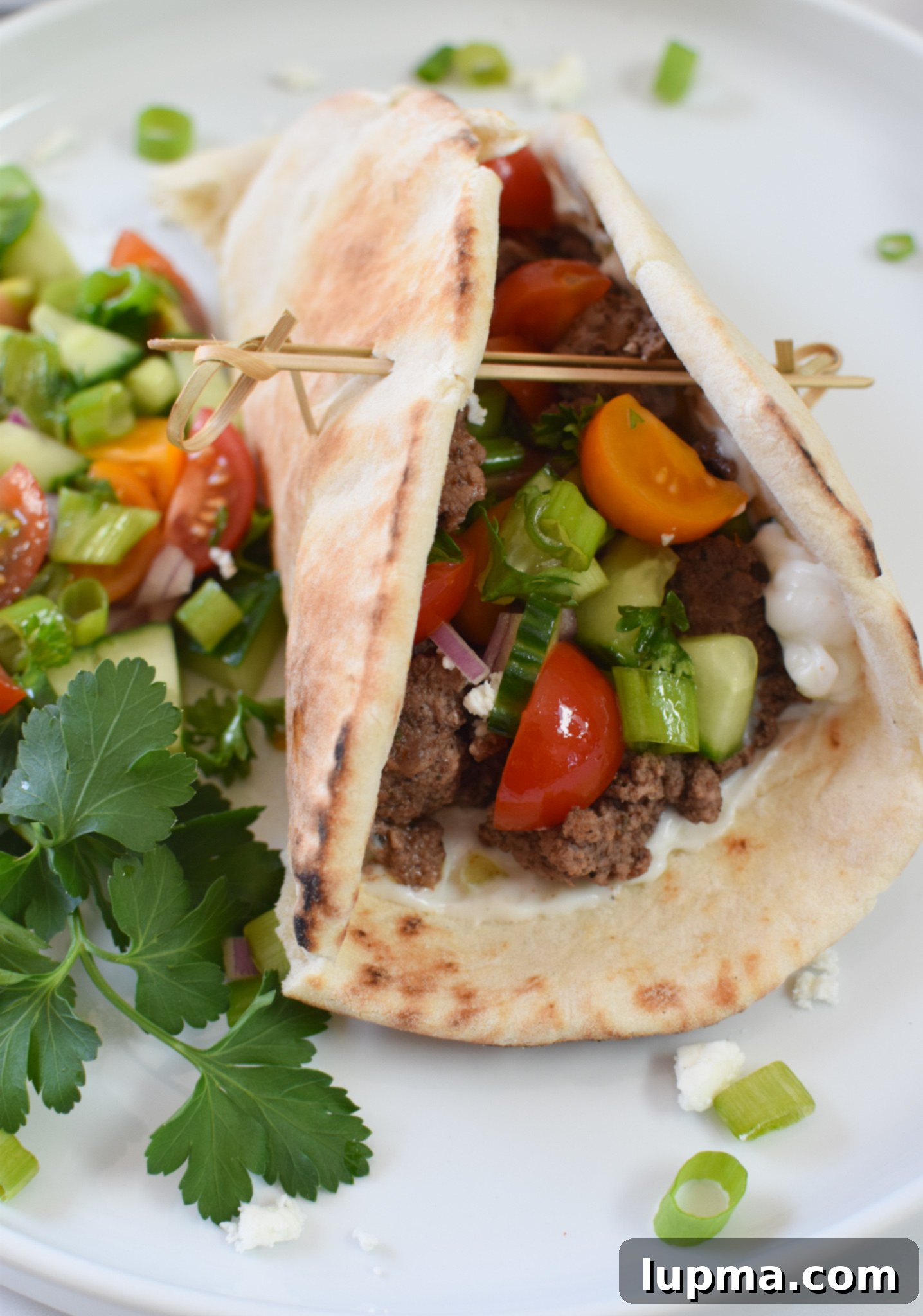 Spiced Lamb Pita Delight 4 Cooked spiced ground lamb simmering in a skillet, ready for pita assembly.