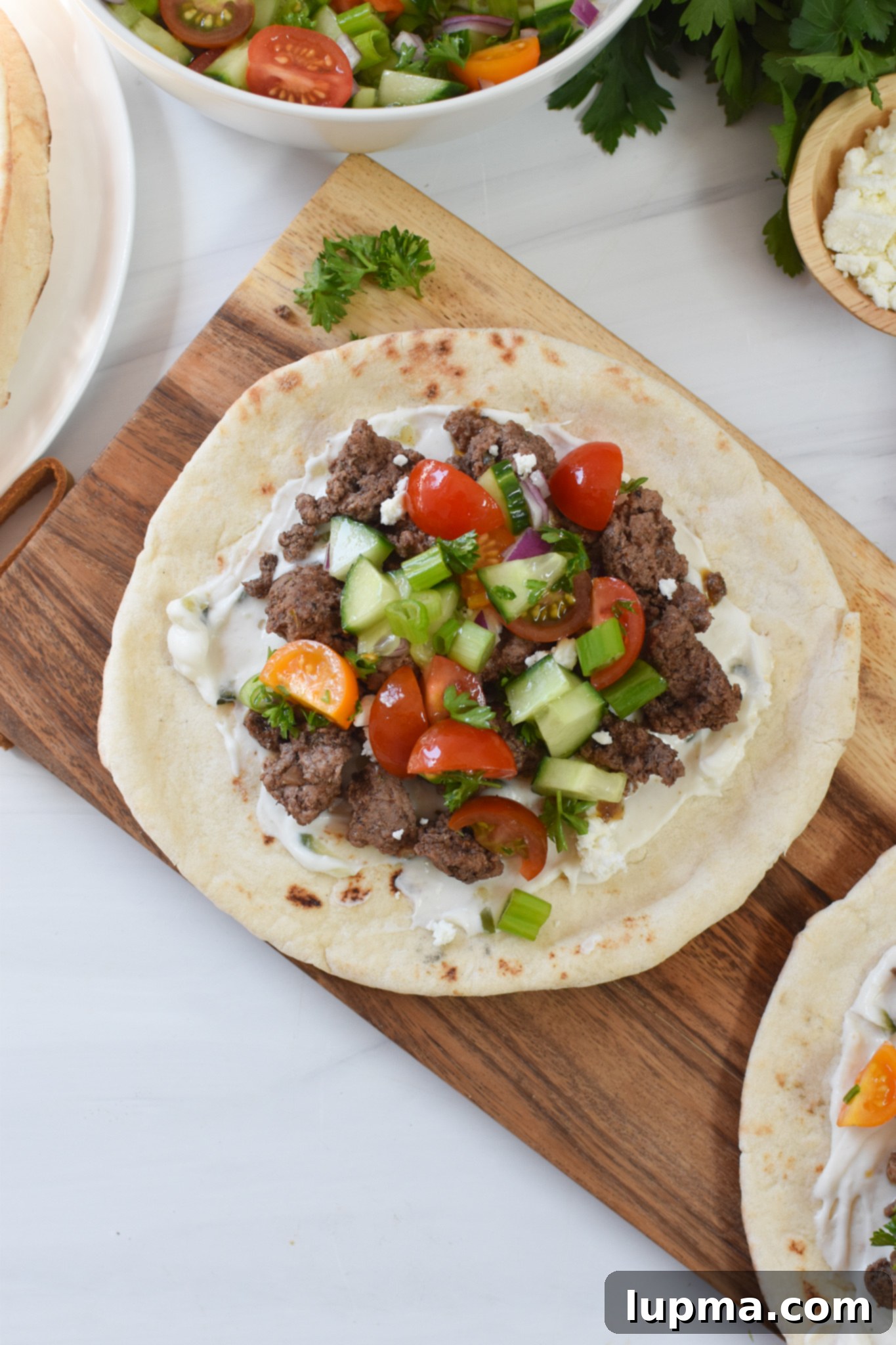 Spiced Lamb Pita Delight 7 A close-up of the Spiced Ground Lamb Pita, showing the delicious Greek topping and tzatziki.