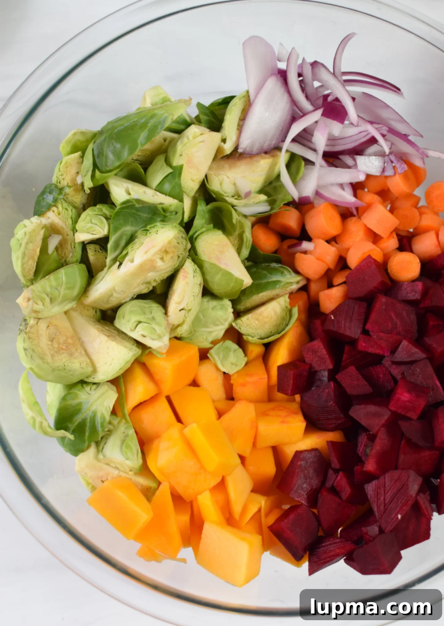 Autumn's Bounty Salad 6 Assortment of prepped vegetables for Fall Harvest Salad in a mixing bowl, ready for roasting.