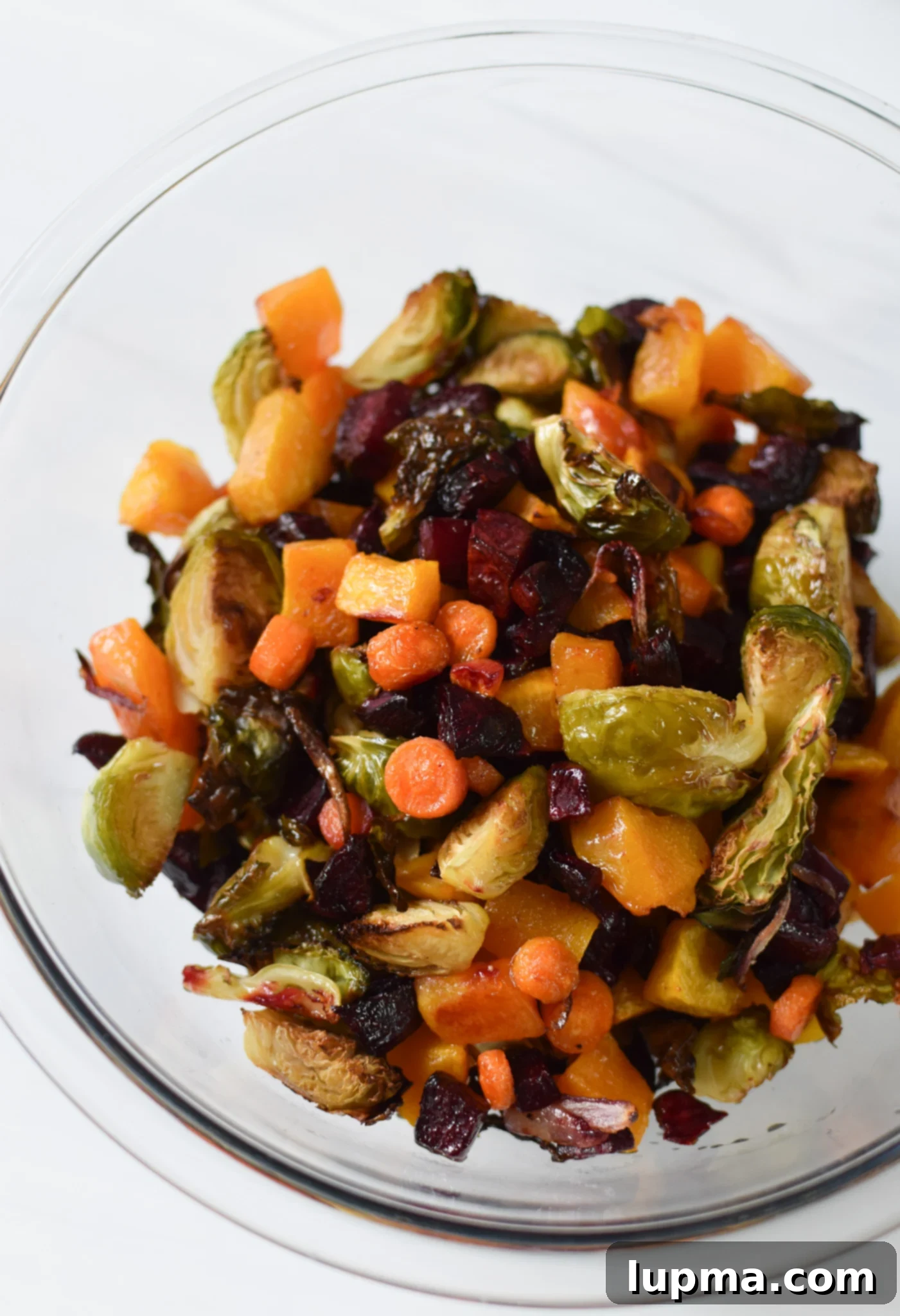 Autumn's Bounty Salad 7 Tray of roasted butternut squash, Brussels sprouts, beets, and carrots, golden and tender.