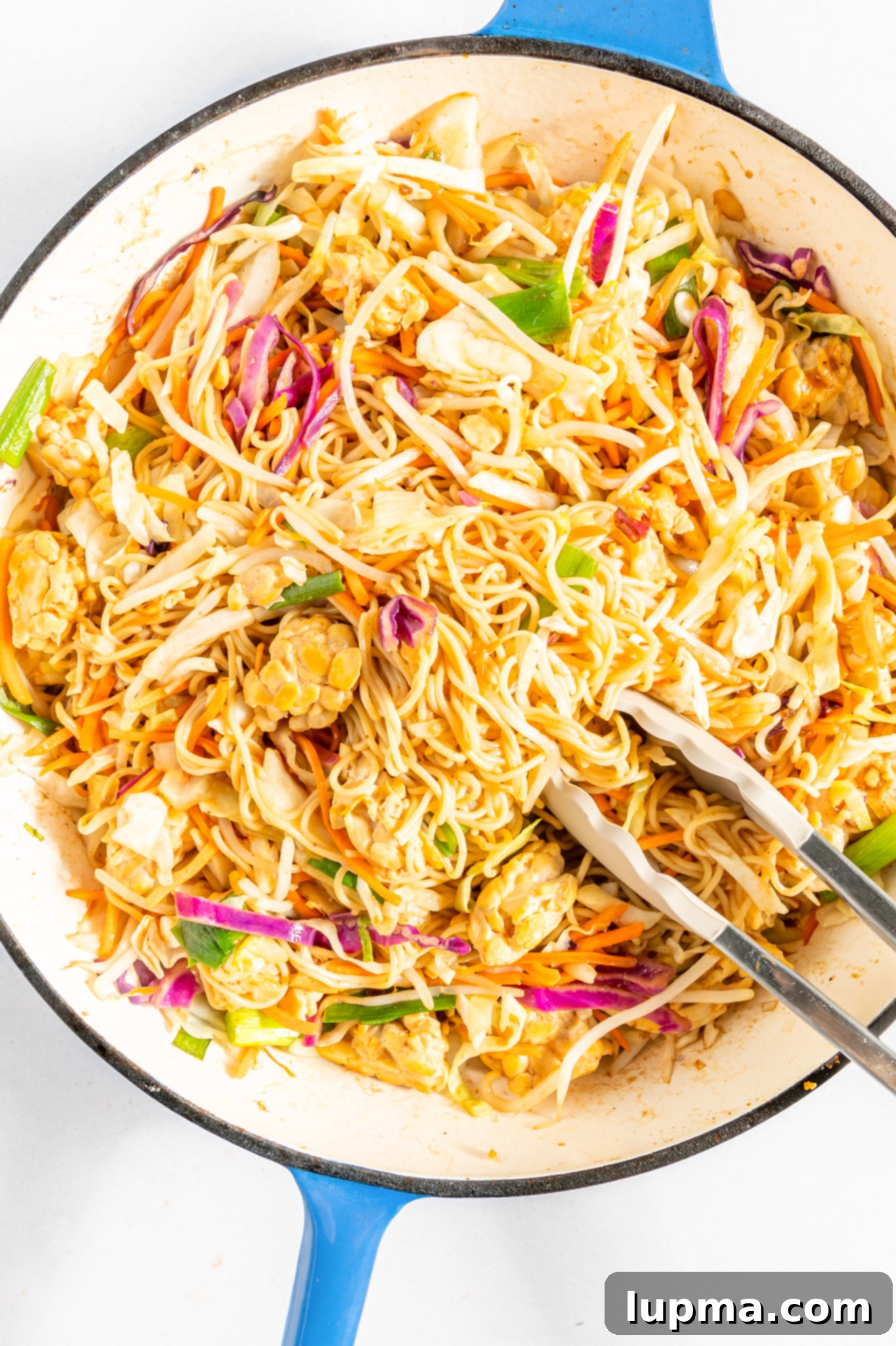 Quick Veggie Noodle Stir-Fry 7 Easy Vegetable Chow Mein with tongs.