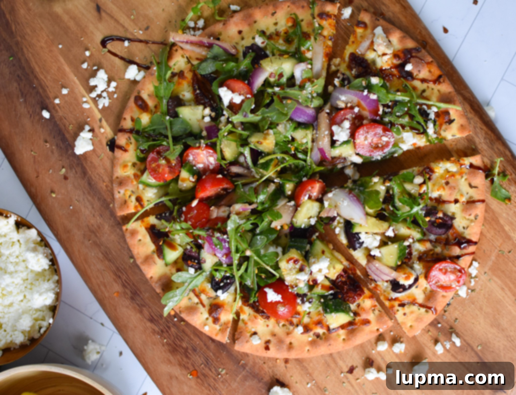 Hellenic Herb & Feta Pizza 4 Greek Pizza on a cutting board