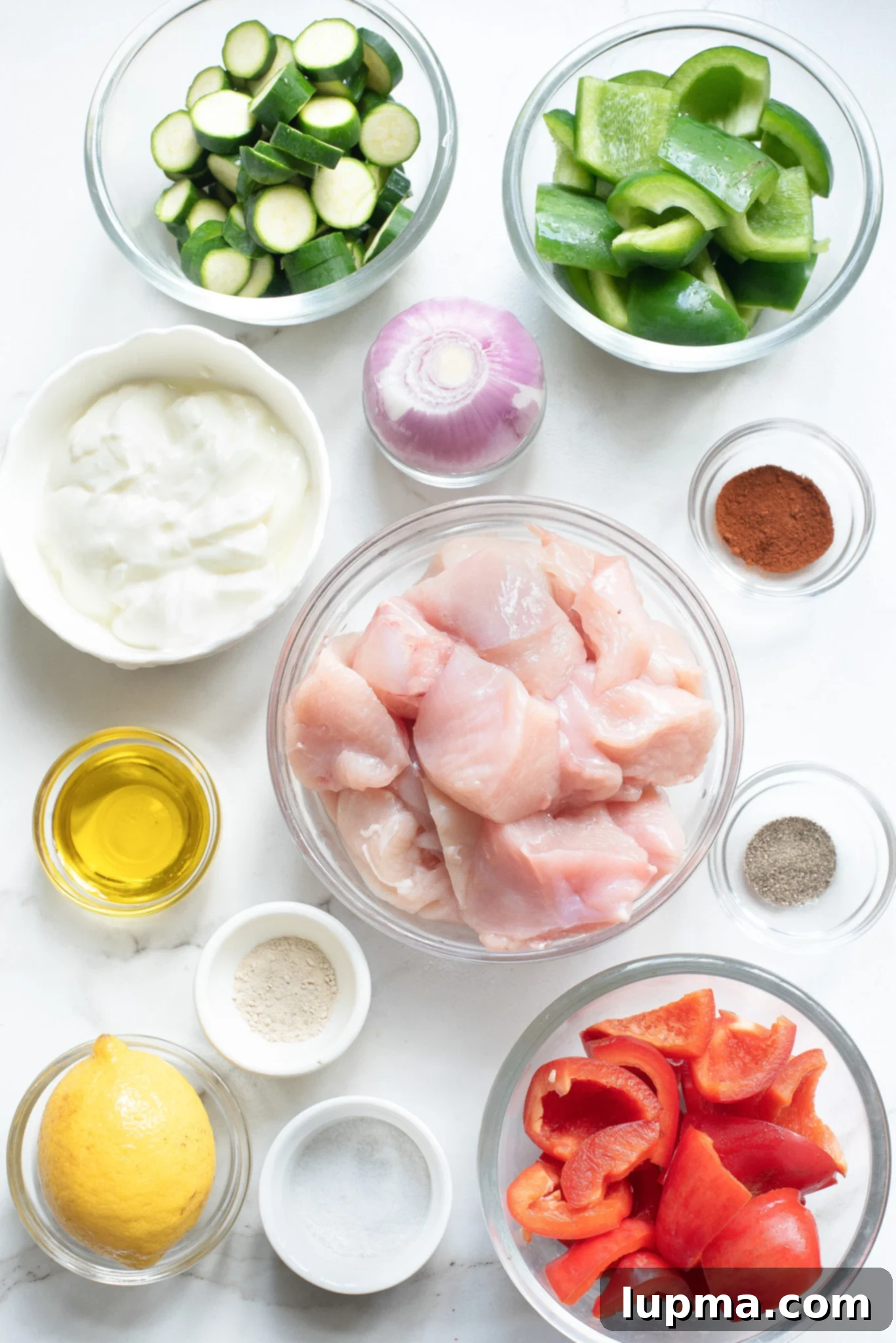 Zesty Greek Lemon Chicken Skewers 3 Fresh ingredients for Greek Marinated Chicken Kabobs with Lemon laid out on a table.