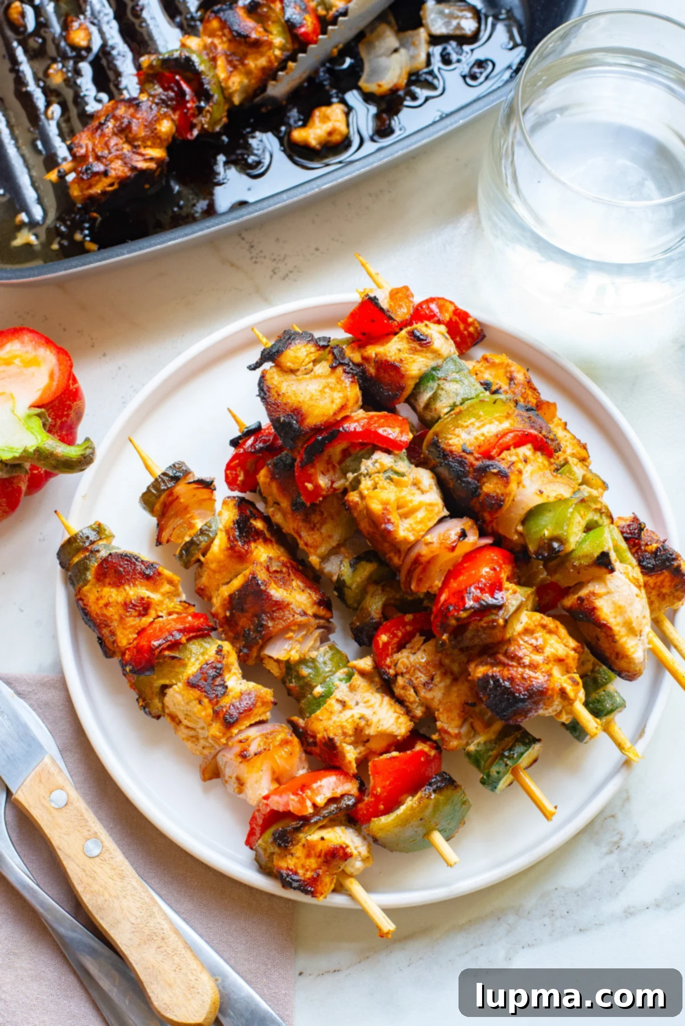 Zesty Greek Lemon Chicken Skewers 7 A plate of freshly grilled Greek Marinated Chicken Kabobs with Lemon, ready to be served.