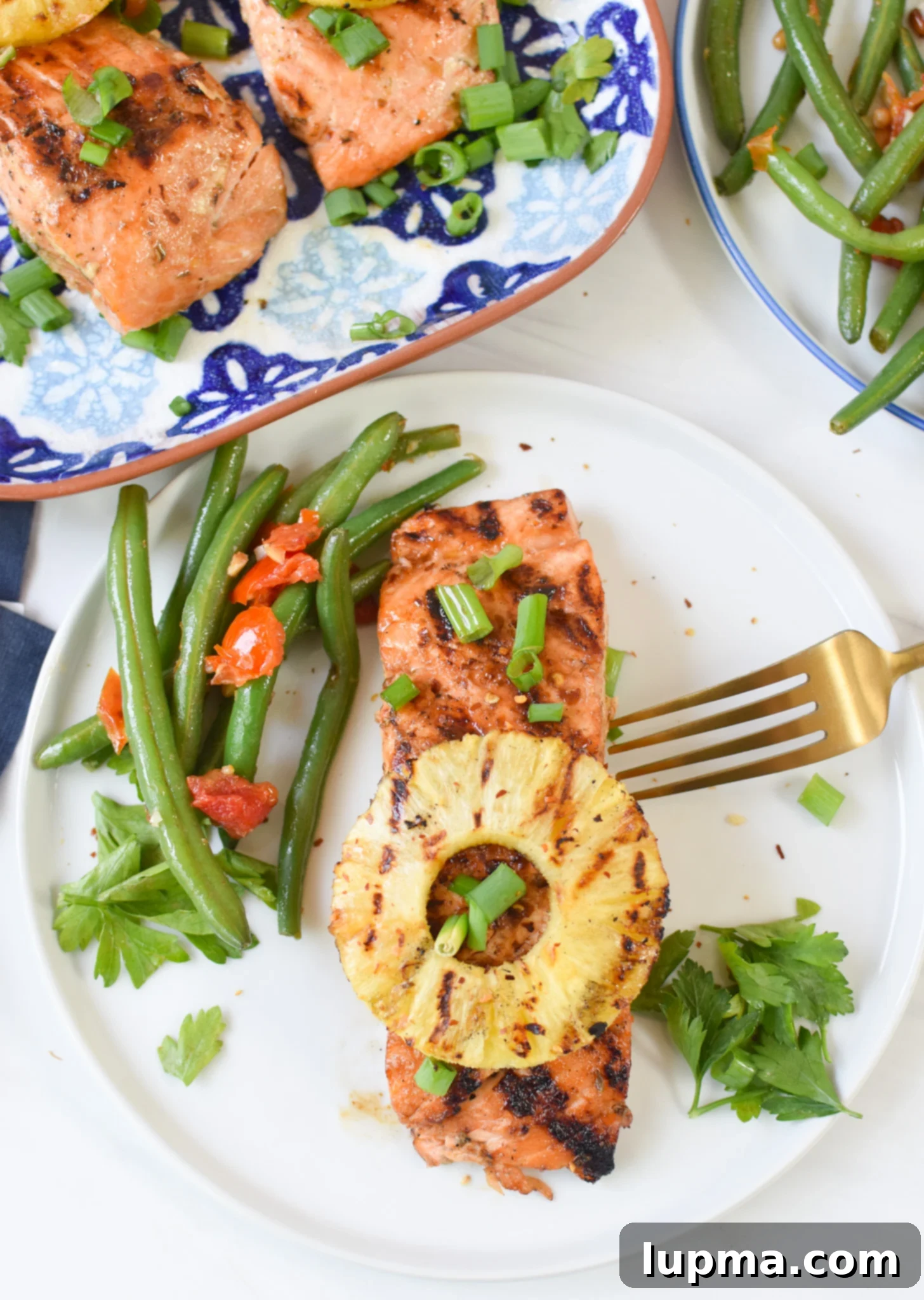 Aloha Grilled Salmon 5 A vibrant platter of Hawaiian Grilled Salmon served with green beans and fresh herbs, ready to be enjoyed.