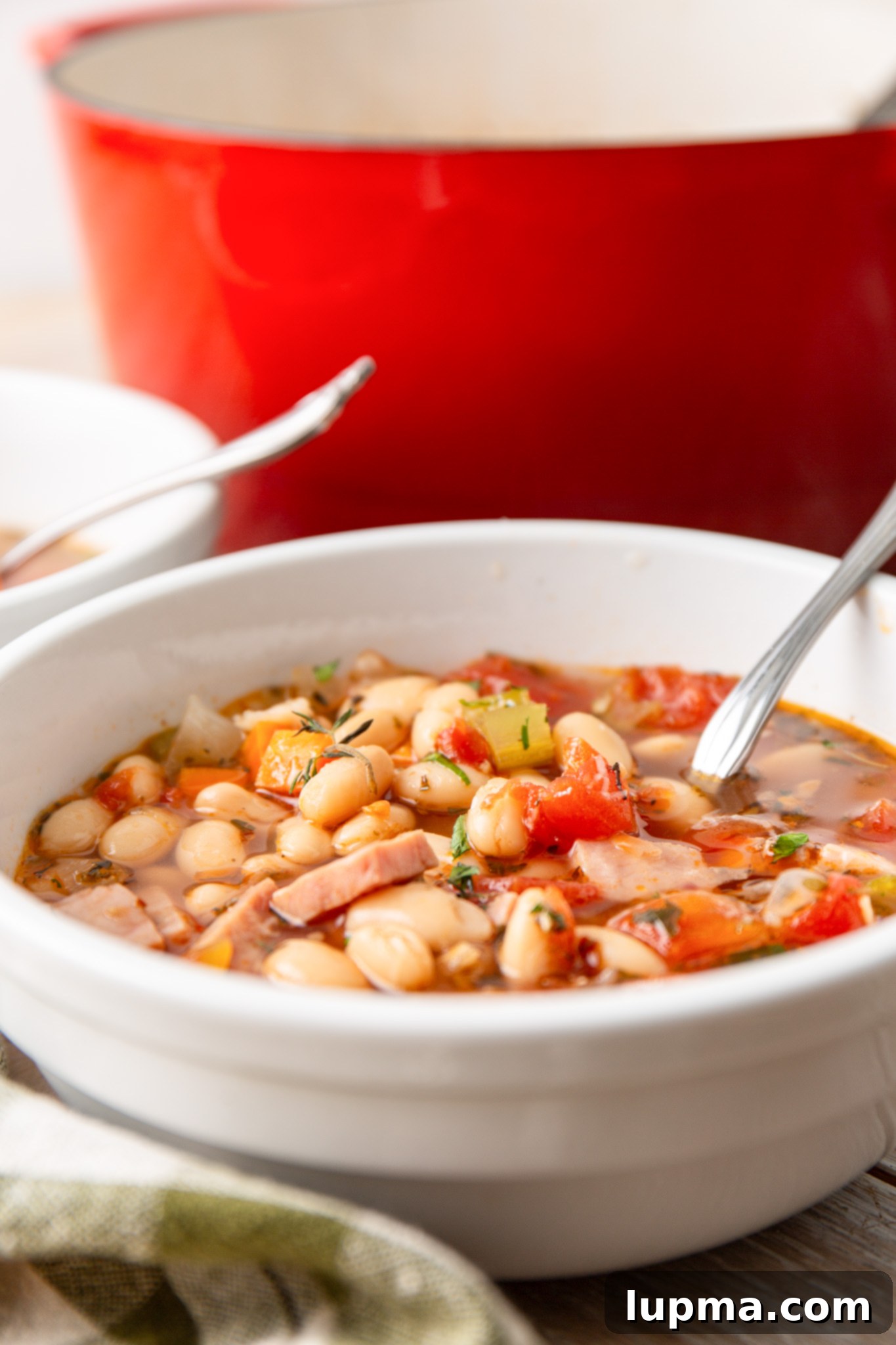Hearty Navy Bean Soup 3 Dutch oven filled with simmering Navy Bean Soup, ready to be served.