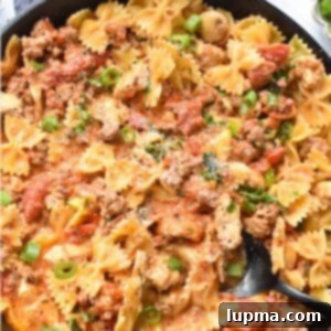 The Ultimate Creamy Chicken & Chorizo Pasta 9 Creamy Chicken and Chorizo Pasta Recipe in a skillet with a spoon